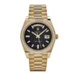 Rolex Day-Date 228398TBR yellow gold watch with onyx dial, baguette diamond hour markers, and diamond-set bezel.