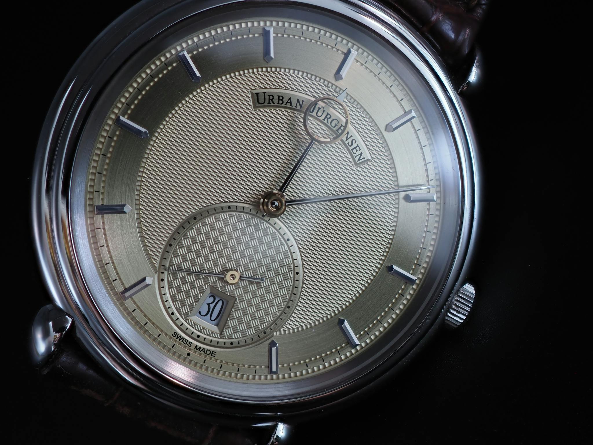 Closeup of a luxury Swiss made watch with intricate design. Ideal for elegant fashion and horology enthusiasts.